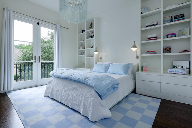 bedroom with access to exterior, dark hardwood / wood-style flooring, french doors, and a chandelier