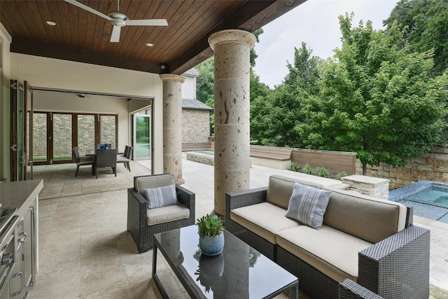 view of patio / terrace with ceiling fan and an outdoor living space