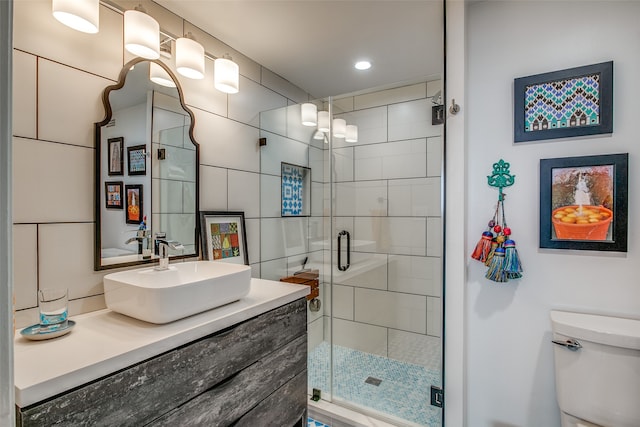 bathroom with vanity, an enclosed shower, and toilet