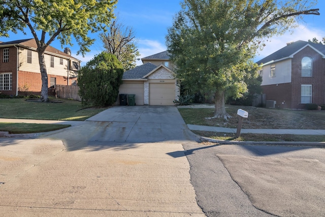 front of property with a front yard and a garage