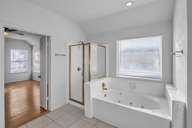 bathroom featuring a wealth of natural light, shower with separate bathtub, and vaulted ceiling