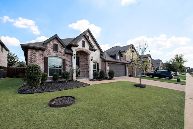 french country home featuring central AC, a front yard, and a garage