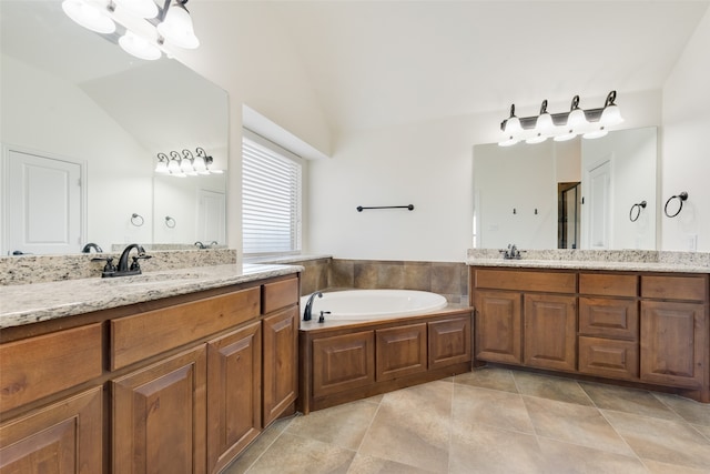 bathroom with vanity, lofted ceiling, tile patterned flooring, and a tub