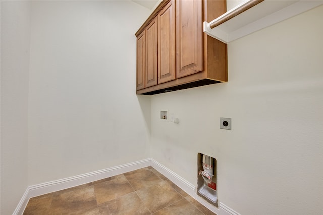 washroom with hookup for a washing machine, hookup for an electric dryer, light tile patterned floors, cabinets, and gas dryer hookup