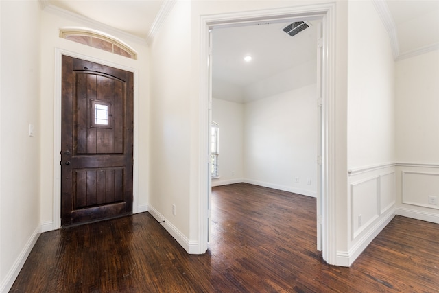 entryway featuring ornamental molding and dark hardwood / wood-style flooring