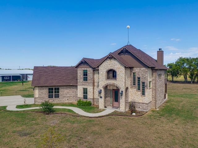 french country style house with a front yard