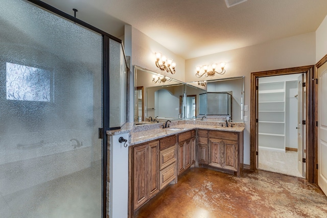 bathroom featuring concrete flooring, a shower with shower door, and vanity