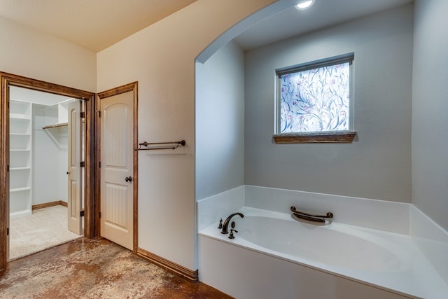 bathroom featuring a tub to relax in