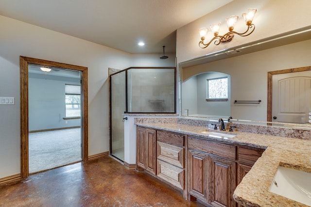 bathroom with vanity, an enclosed shower, and concrete floors