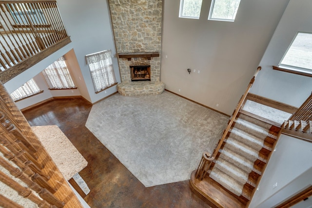 living room with a high ceiling and a fireplace