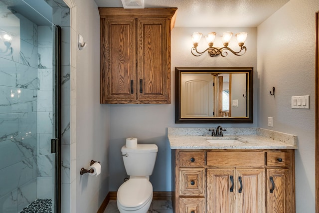 bathroom with vanity, a textured ceiling, a shower with shower door, and toilet