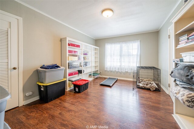 recreation room featuring dark hardwood / wood-style floors and ornamental molding