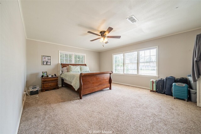 carpeted bedroom featuring ceiling fan and crown molding