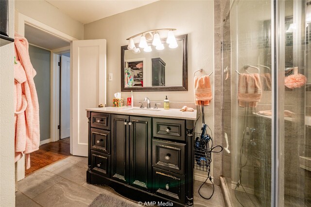 bathroom featuring vanity, hardwood / wood-style floors, and a shower with shower door