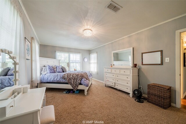 bedroom with ornamental molding and carpet flooring