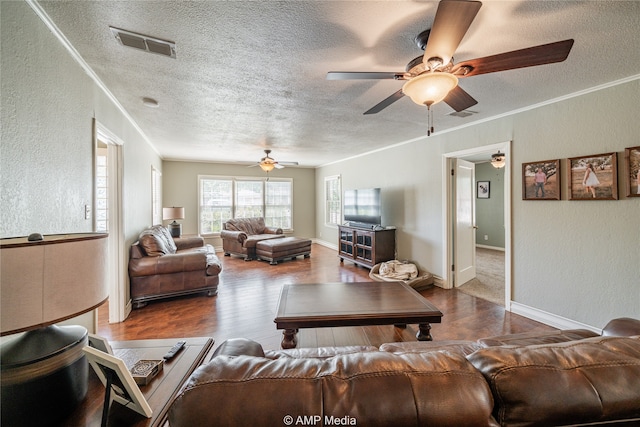 living room featuring a textured ceiling, crown molding, hardwood / wood-style floors, and ceiling fan