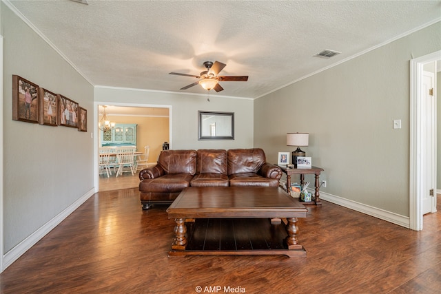 living room featuring ceiling fan with notable chandelier, a textured ceiling, dark wood-type flooring, and crown molding