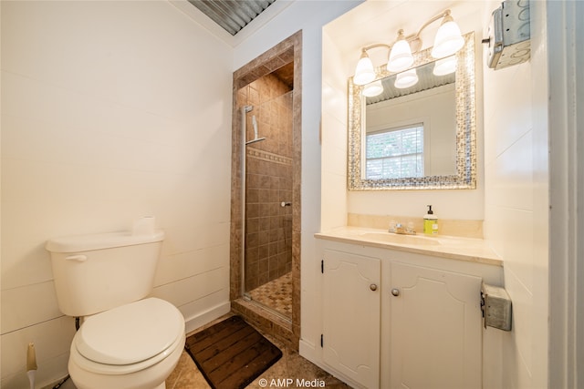 bathroom featuring a tile shower, vanity, and toilet