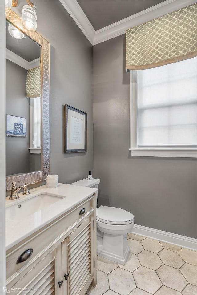 bathroom featuring crown molding, vanity, toilet, and tile patterned floors