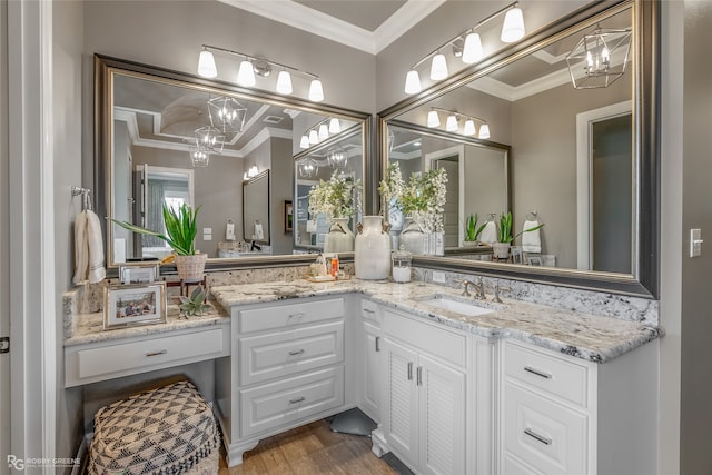 bathroom featuring a chandelier, hardwood / wood-style flooring, vanity, and crown molding