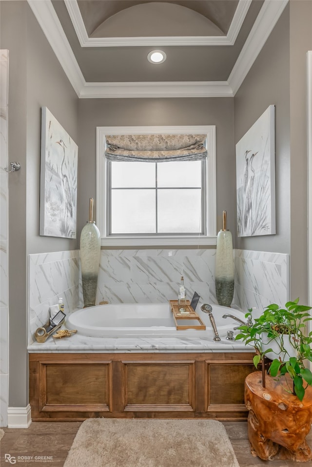 bathroom with hardwood / wood-style flooring, a tub, and crown molding