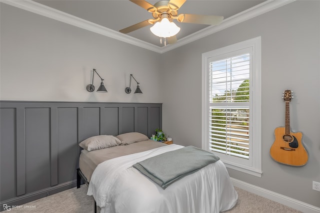 carpeted bedroom featuring ceiling fan and crown molding