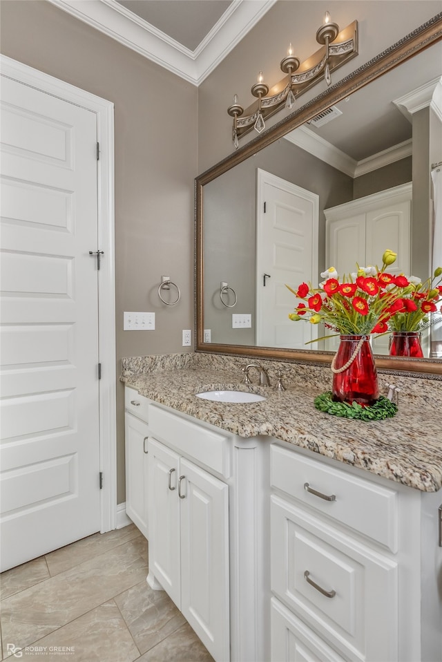 bathroom with crown molding and vanity