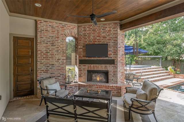 view of patio / terrace featuring an outdoor living space with a fireplace and ceiling fan