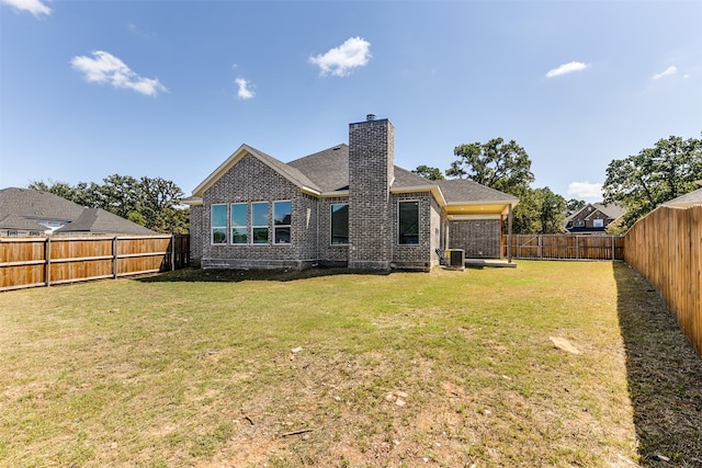 back of property featuring a lawn and cooling unit