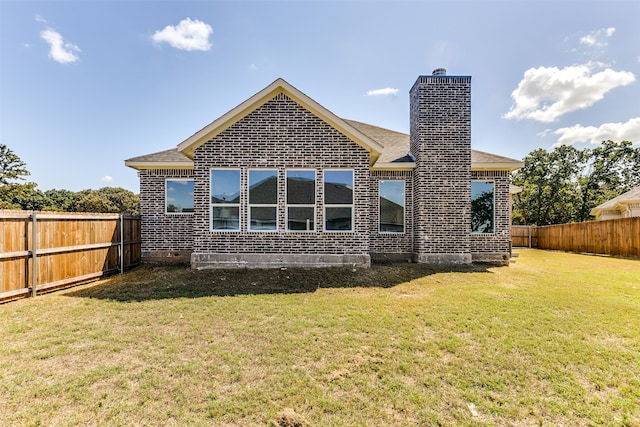 back of house with a lawn