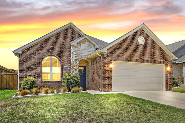 view of front property featuring a garage and a lawn