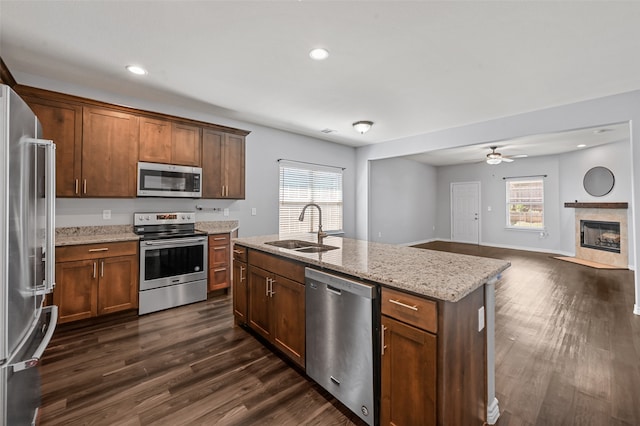 kitchen featuring stainless steel appliances, a center island with sink, dark hardwood / wood-style flooring, and sink