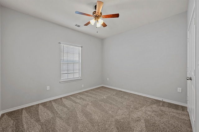 carpeted spare room with ceiling fan