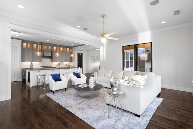 living room with dark hardwood / wood-style flooring, crown molding, and ceiling fan