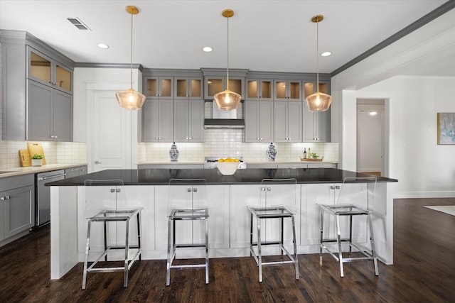 kitchen with a spacious island, dishwasher, a breakfast bar area, and decorative light fixtures