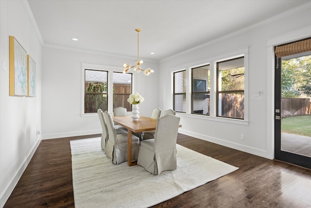 dining area with a wealth of natural light, dark wood-type flooring, a chandelier, and ornamental molding