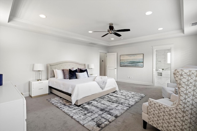 bedroom featuring ceiling fan, carpet floors, a raised ceiling, and connected bathroom