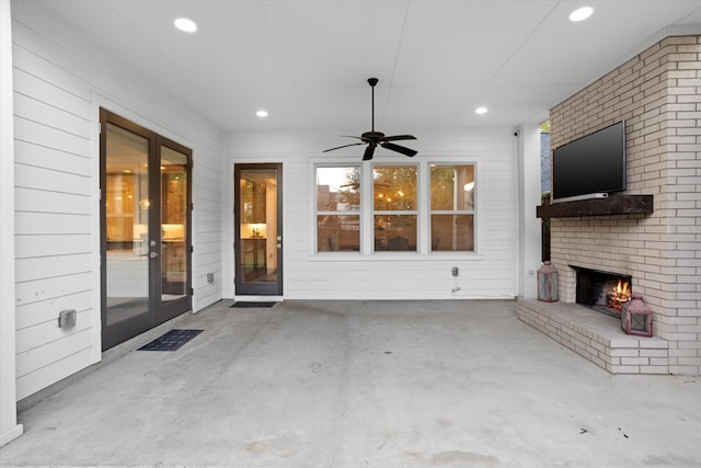 view of patio / terrace featuring a brick fireplace and ceiling fan