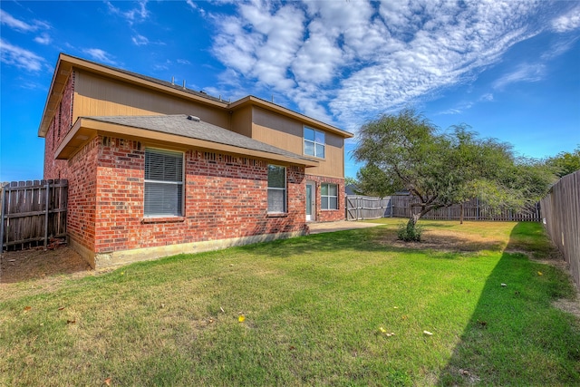 rear view of property with a lawn