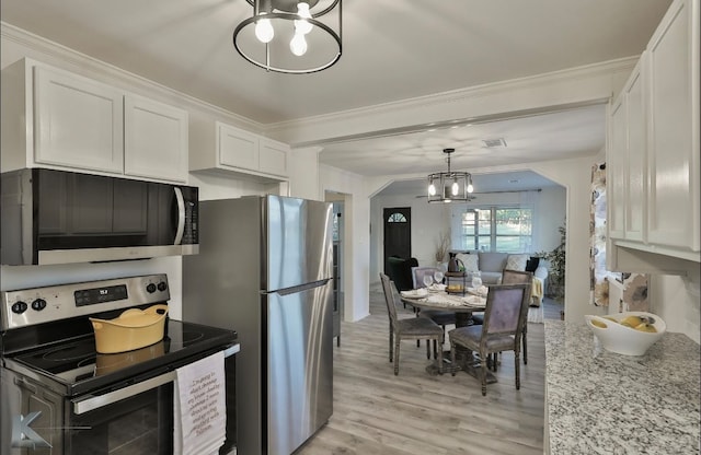 kitchen featuring white cabinets, appliances with stainless steel finishes, an inviting chandelier, crown molding, and light hardwood / wood-style floors