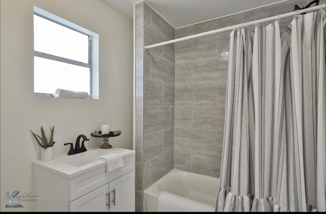 bathroom featuring shower / bath combo and vanity