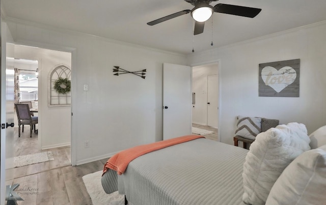 bedroom with ceiling fan, light hardwood / wood-style flooring, and ornamental molding