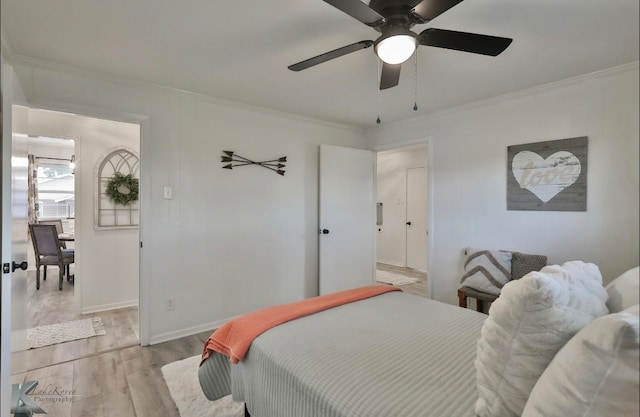 bedroom featuring light wood-type flooring, ceiling fan, and crown molding