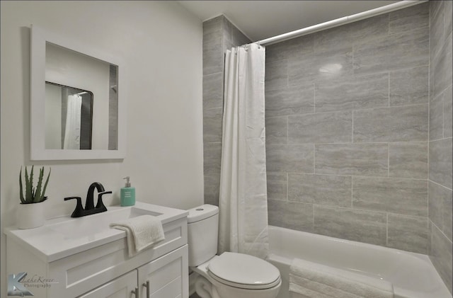 full bathroom featuring shower / tub combo, vanity, and toilet