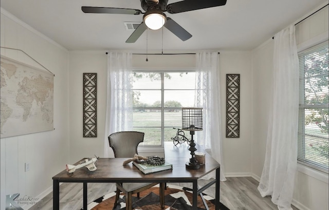 office space featuring light wood-type flooring, ornamental molding, and ceiling fan