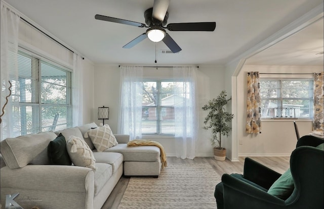 living room featuring light hardwood / wood-style floors and ceiling fan