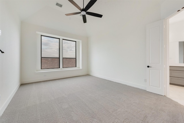 carpeted spare room featuring ceiling fan and lofted ceiling