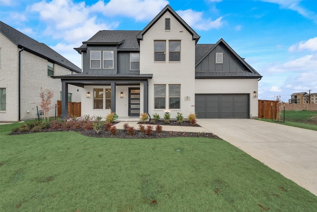 view of front of property featuring a front yard, a porch, and a garage