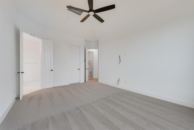 spare room featuring light carpet and ceiling fan