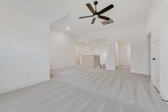 unfurnished living room featuring ceiling fan and light colored carpet